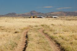 Photo of Quebec Ranch, grassland, road, and ranch buildings